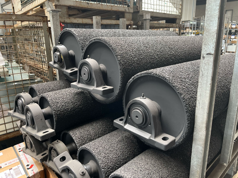 Epoxy-corundum coated rollers for high grip and long life